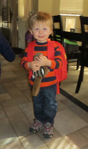 Wearing his backpack and holding Peanut, his chipmunk, who goes with him, every day!