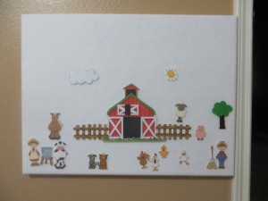 This is the felt board I made for him...mounted on the wall just inside the room, down low so he can use it.  I didn't make these farm pieces, just the board, FYI.